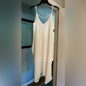 Vestique White lined with asymmetrical bottom. Super fun for day or night!